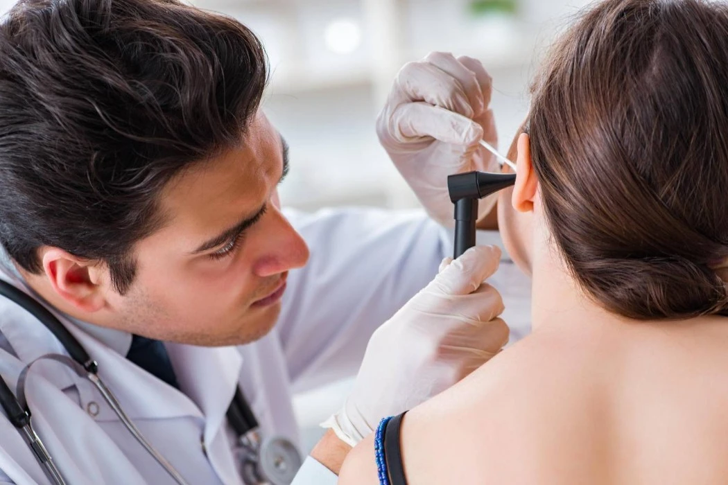 Pharmacist performing an ear wax removal
